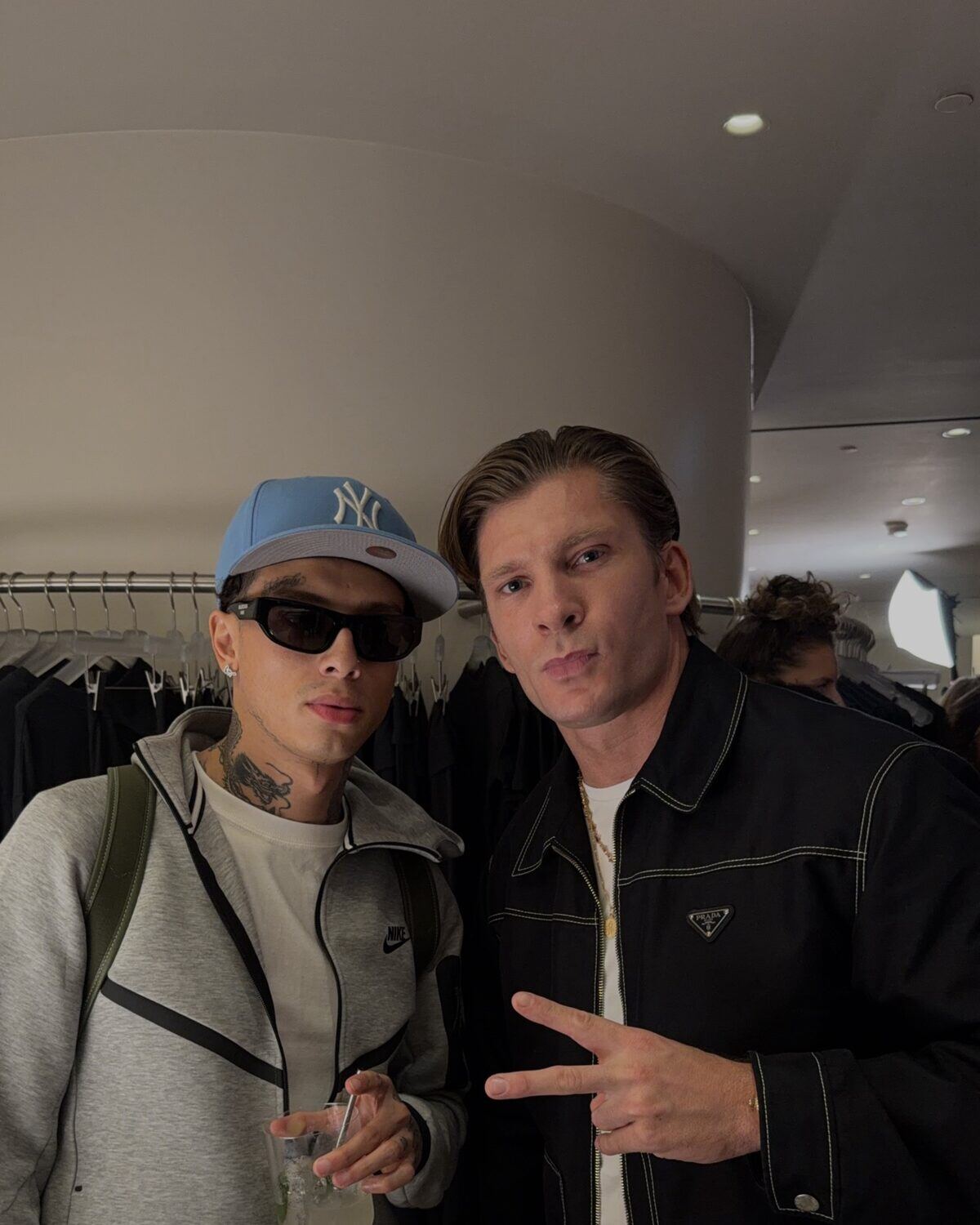 Two men in designer outerwear inside a luxury store