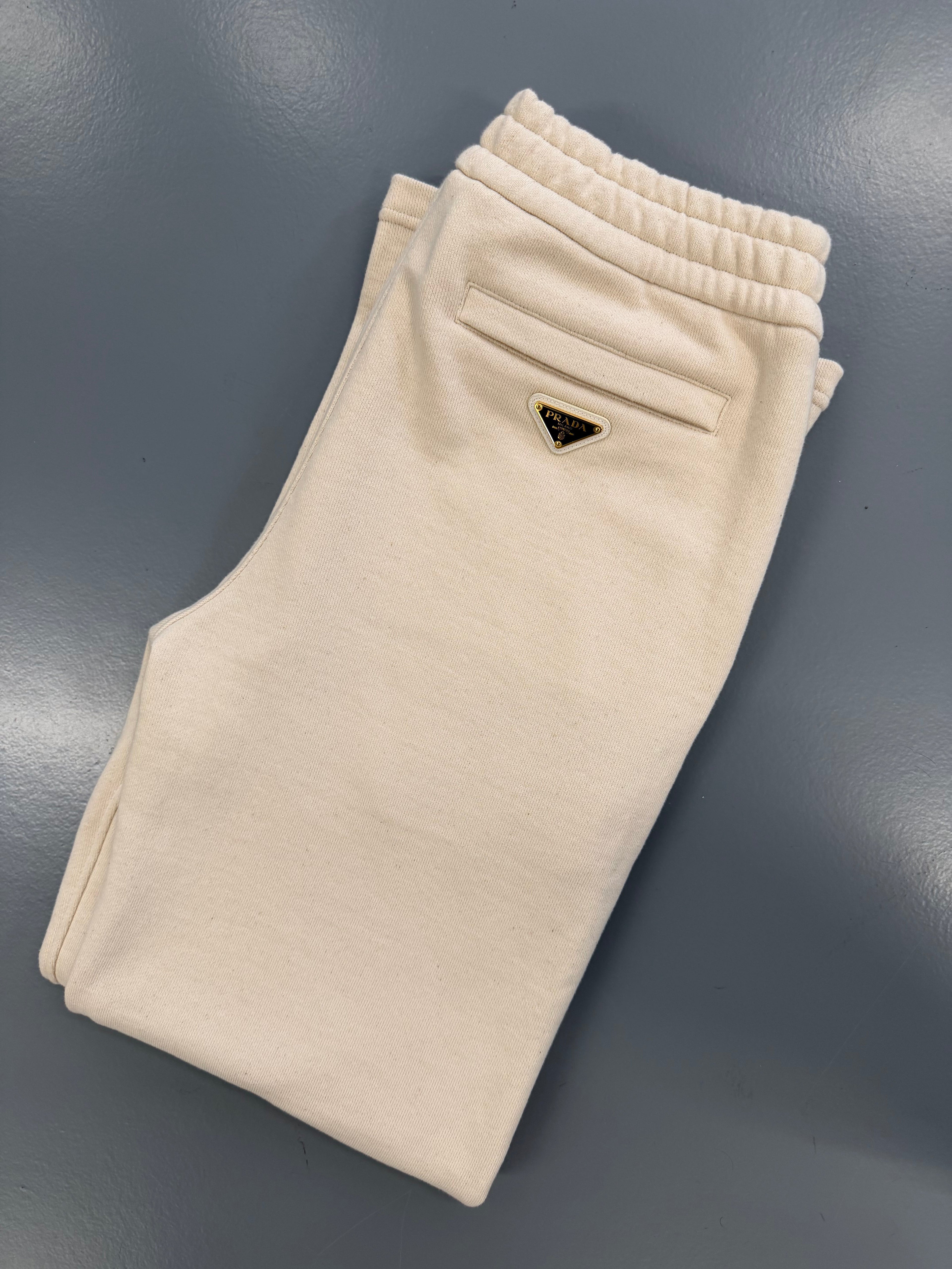 PRADA BEIGE PLAQUE TRACK PANTS - SMALL (Fit Large) - Affluent ArchivesUsed HIGH END DESIGNER CLOTHING